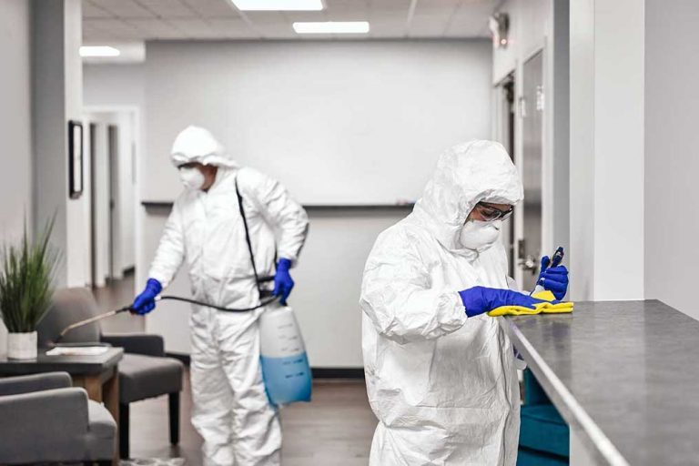Disinfecting crew deep cleaning an office space