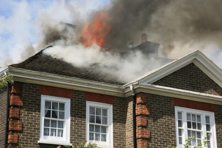 Fire coming through roof of a home