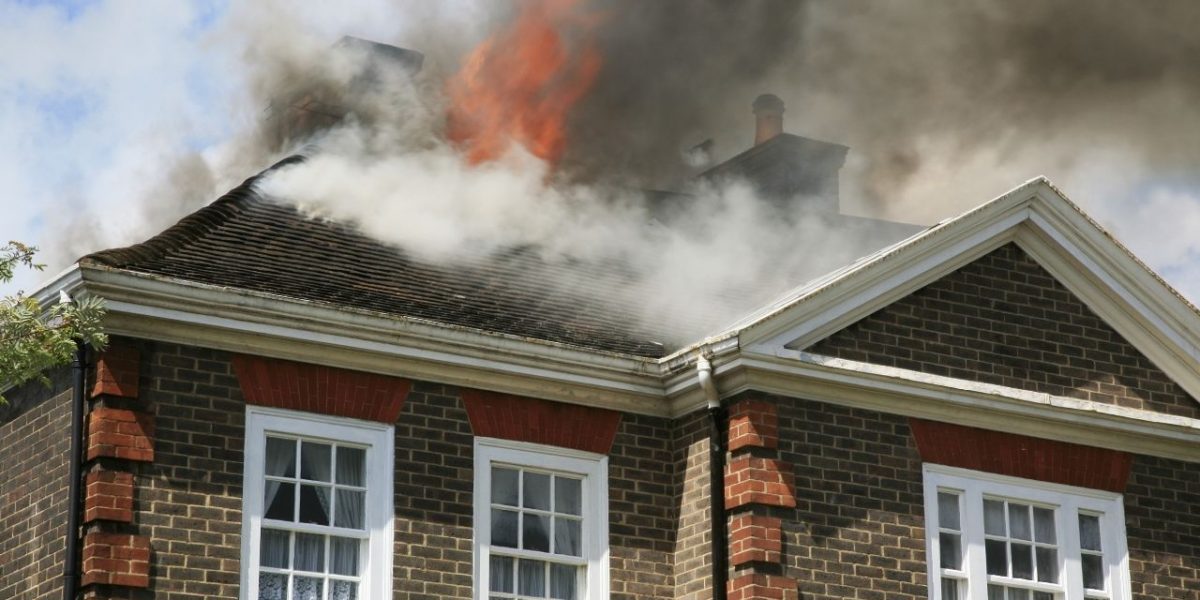 Fire coming through roof of a home